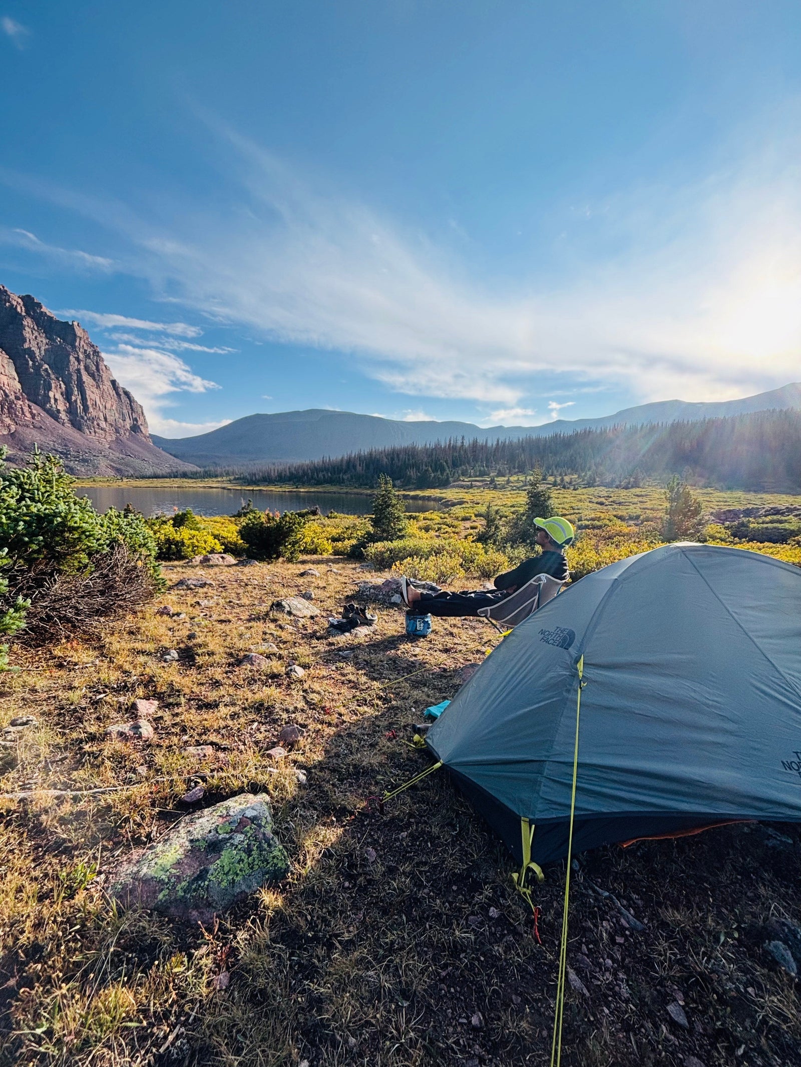Saurav camped beside a mountain lake in the High Uintas at golden hour