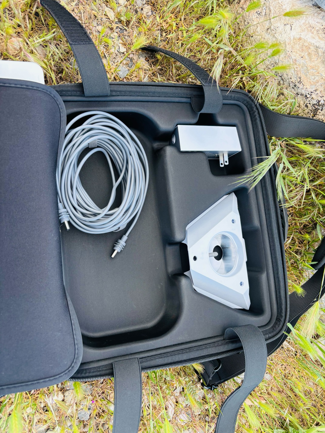Yedralune case accessories compartment showing Starlink cable, power adapter, and kickstand stored neatly