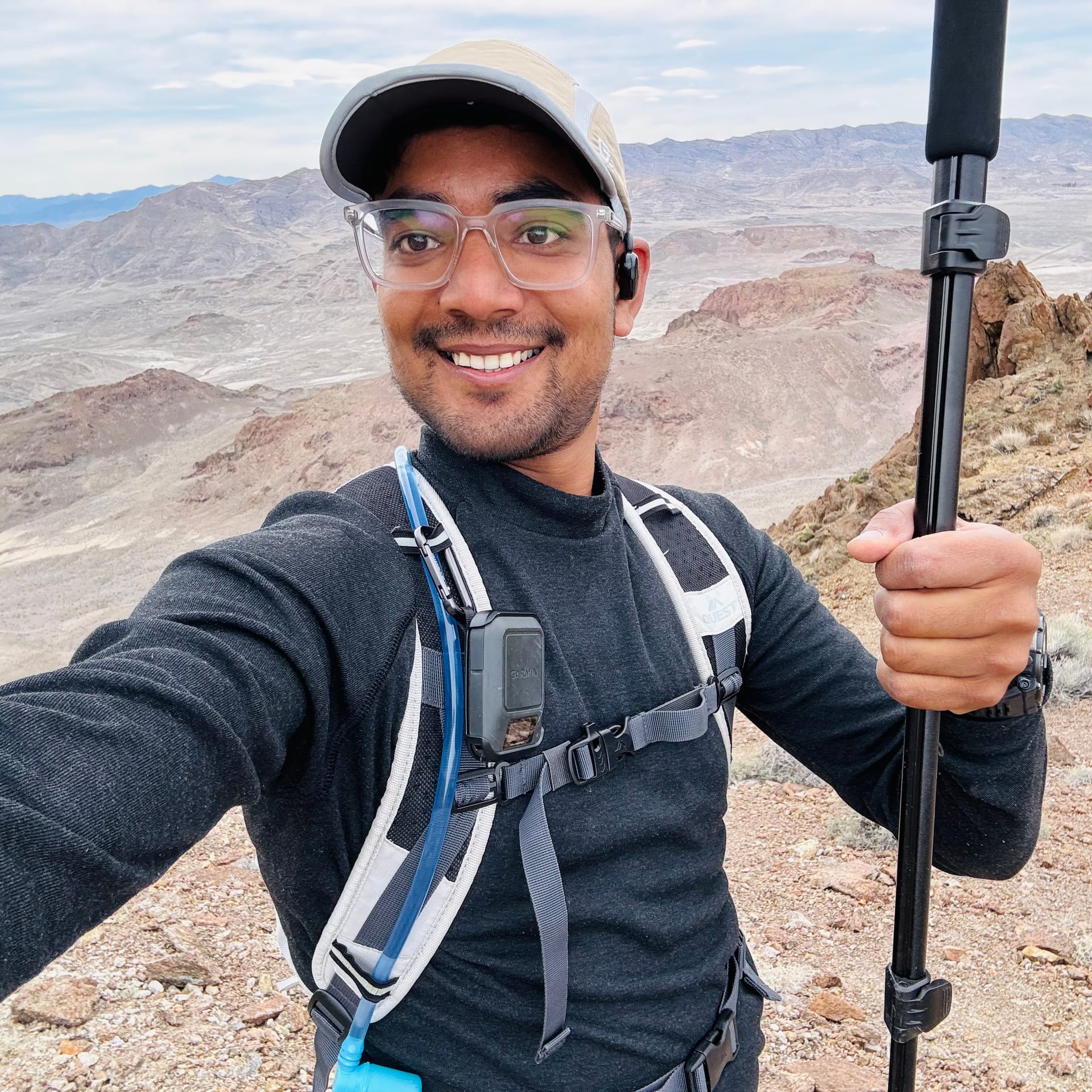 Relaxing on the summit rocks with trails and salt flats visible far below